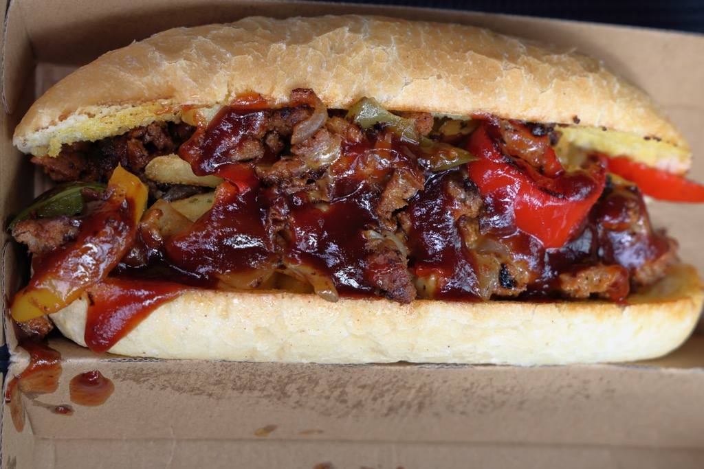 Cheesesteak stacked high with melted cheese.