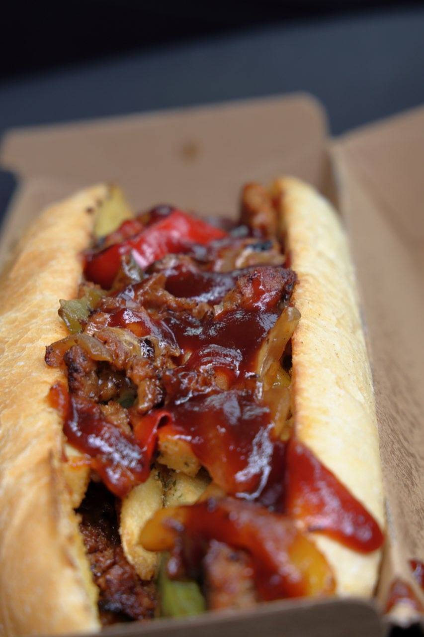 Golden chips piled under loaded cheesesteak topping.